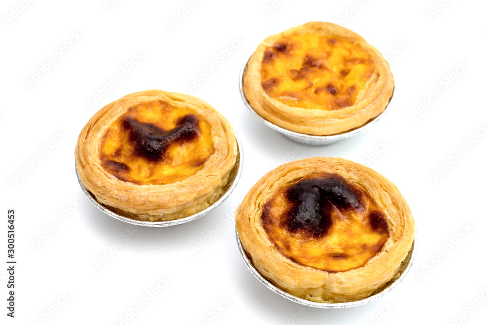 egg tart in aluminum foil cup isolated on white background egg tart in aluminum foil cup isolated on white background