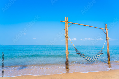 Empty hammock swing on the beautiful beach and sea