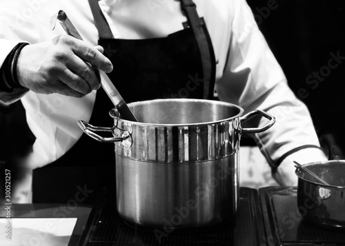 chef cooking in a kitchen, chef at work, Black & White background