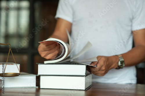 Legal concept of law Lawyers read legal documents and agreements on office desks.