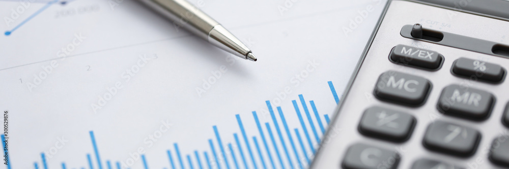 Pen lie on blue financial statistic analisys chart Pen lie on blue financial statistic analisys chart