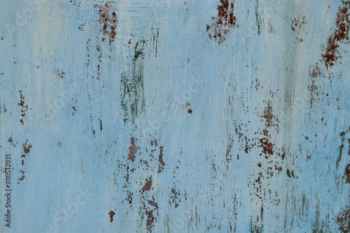 The metal surface is carelessly painted in blue, traces of rust.