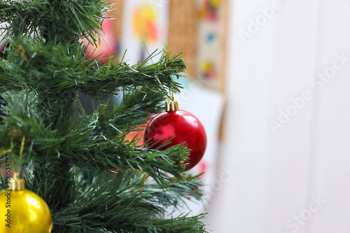 Decorated artificial Christmas tree in a bright children's room on Christmas Eve. happy childhood, christmas miracle. selective focus, place for text, copy space