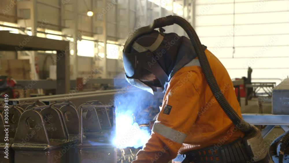 custom made wallpaper toronto digitalSteel worker with oxygen mask welding on steel installation in factory hall- camera dolly movement - direction left