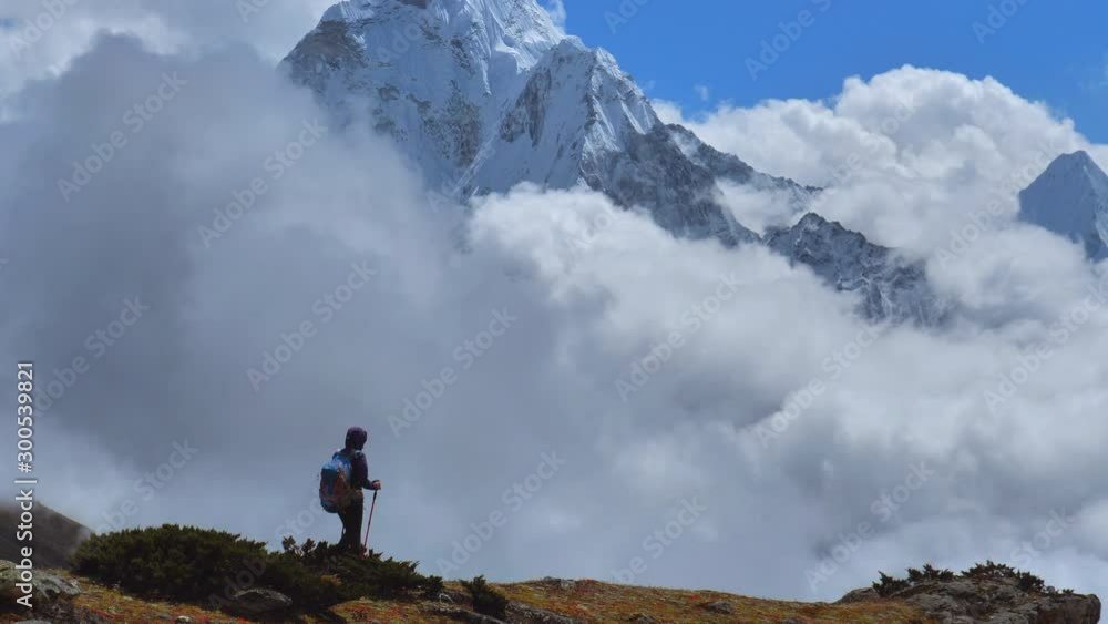 Active hiker hiking in Himalaya Nepal mountains.Walking in Way to Everest base camp. Travel sport lifestyle concept Active hiker hiking in Himalaya Nepal mountains.Walking in Way to Everest base camp. Travel sport lifestyle concept