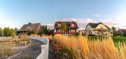 Curving white picket fence with border of grass photo