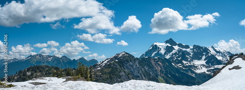 Panoramic view of snowcapped mountains landscape with blue sky and clouds.Mt Shuksan, Washington, USA © Fangzhou
