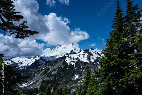 Snowcapped mountains landscape with blue sky and clouds. Mt Baker, Washington, USA