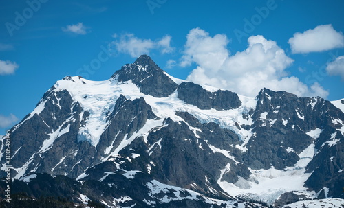 Snow mountain lake landscape  with blue sky and clouds.  Mt Shuksan  Washington  USA