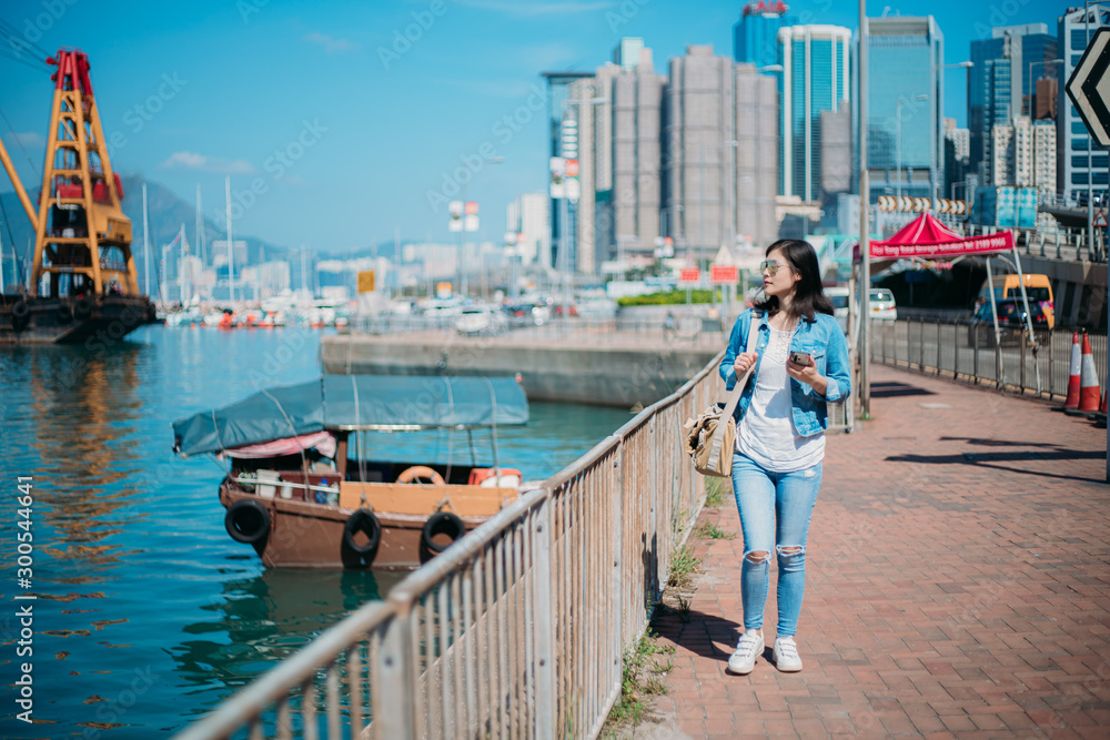 Girl traveling in Hong Kong Causeway Bay waterfront.