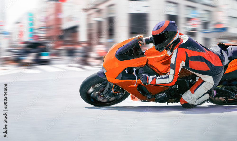 Motorcycle leaning into a fast corner in downtown