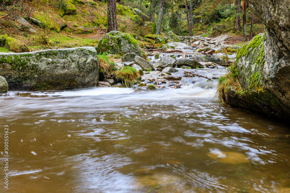Eresma river as it passes through Boca del Asno among the granite rocks in Valsain, Segovia, Spain Eresma river as it passes through Boca del Asno among the granite rocks in Valsain, Segovia, Spain