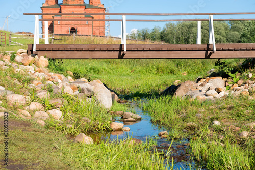 The first bridge over the source of the Volga River. Volgoverkhovye Olginsky convent, Church Transfiguration in Tver Region, Russia photo