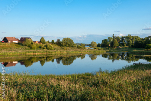 Lake on the outskirts of the village on a summer evening at sunset