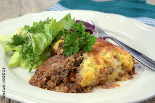 shepherd's pie with salad on a plate