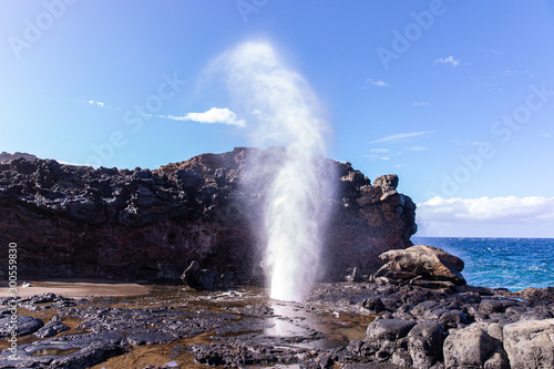 View at a stream of water and steam exploding from Nakalee blowhole, Maui, Hawaii