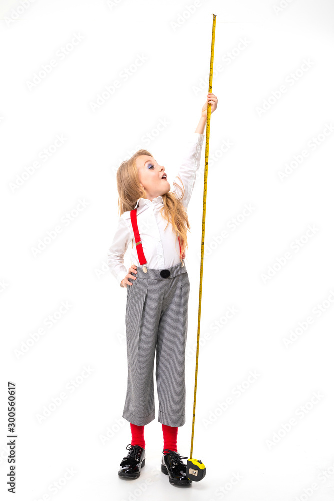Little caucasian girl with tape measure look up, picture isolated on white background Little caucasian girl with tape measure look up, picture isolated on white background