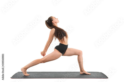A beautiful young woman gymnast with dark long hair does warm-up and stretch her muscles
