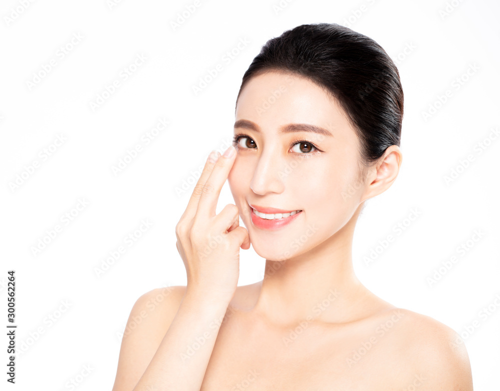 Young woman putting contact lens in her eye Young woman putting contact lens in her eye