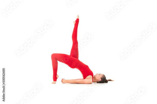 Young caucasian gymnast with athletic body doing yoga and meditating