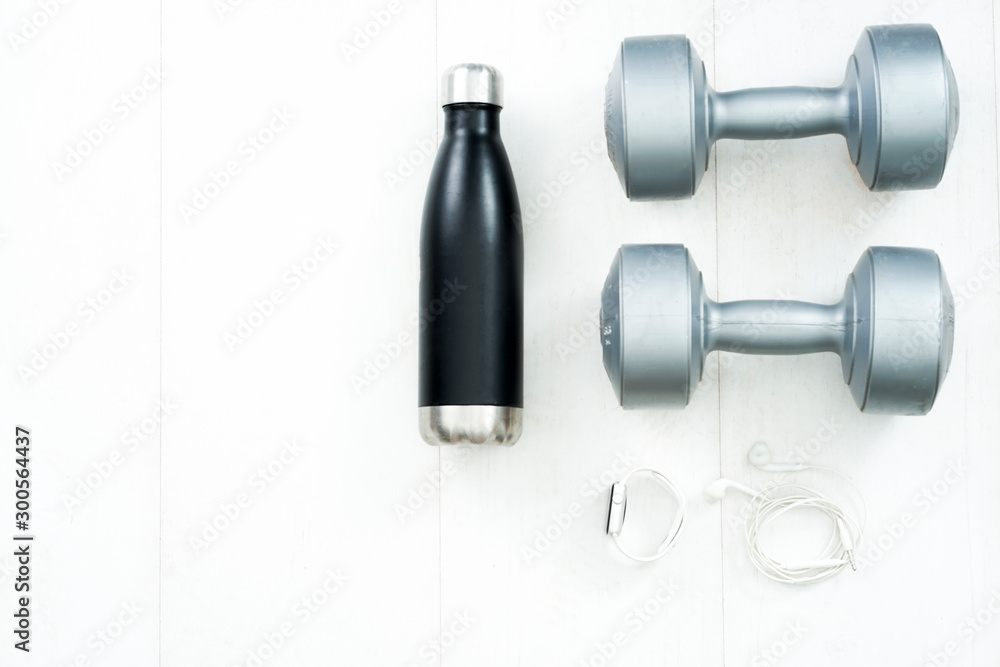Fitness tracking concept. Using smartwatches and smartphones to track fitness activities. Running shoes and smartwatch on white wooden flat lay view. Fitness tracking concept. Using smartwatches and smartphones to track fitness activities. Running shoes and smartwatch on white wooden flat lay view.