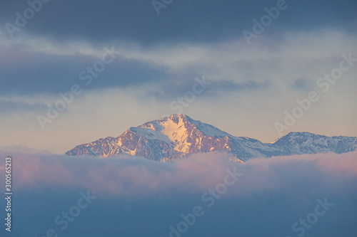 Far distant snowy mountain top during sunrise