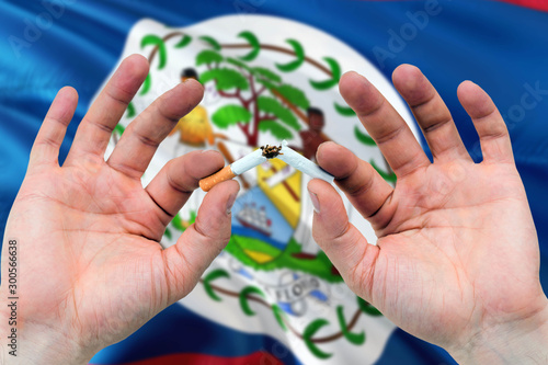 Wallpaper Mural Belize quit smoking cigarettes concept. Adult man hands breaking cigarette. National health theme and country flag background. Torontodigital.ca