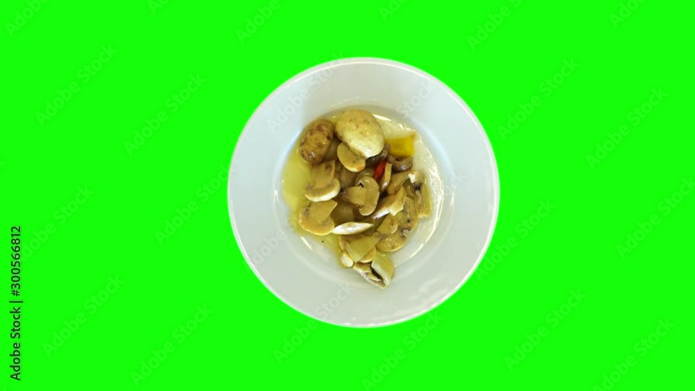 Plate rotates on the table, top view. On a spinning plate, a delicious dish of stewed mushrooms. Healthy food concept. Plate rotates on the table, top view. On a spinning plate, a delicious dish of stewed mushrooms. Healthy food concept.