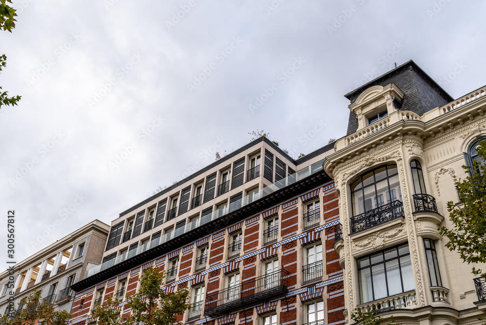 Old luxury residential buildings with balconies in Serrano Street in Salamanca district in Madrid