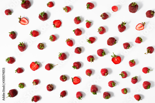 Berries of fresh ripe strawberries on a white surface. Top view.