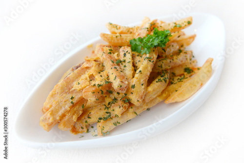French fries seasoned with Salted Egg on the white plate.