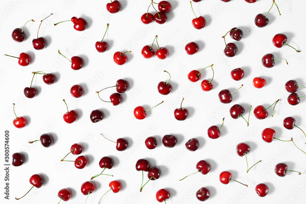 Berries of fresh ripe sweet cherry on a white surface. Top view. Berries of fresh ripe sweet cherry on a white surface. Top view.