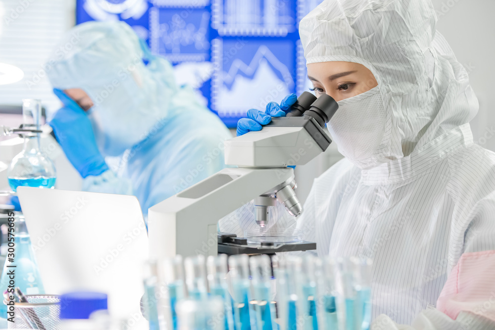 asian scientist use microscope