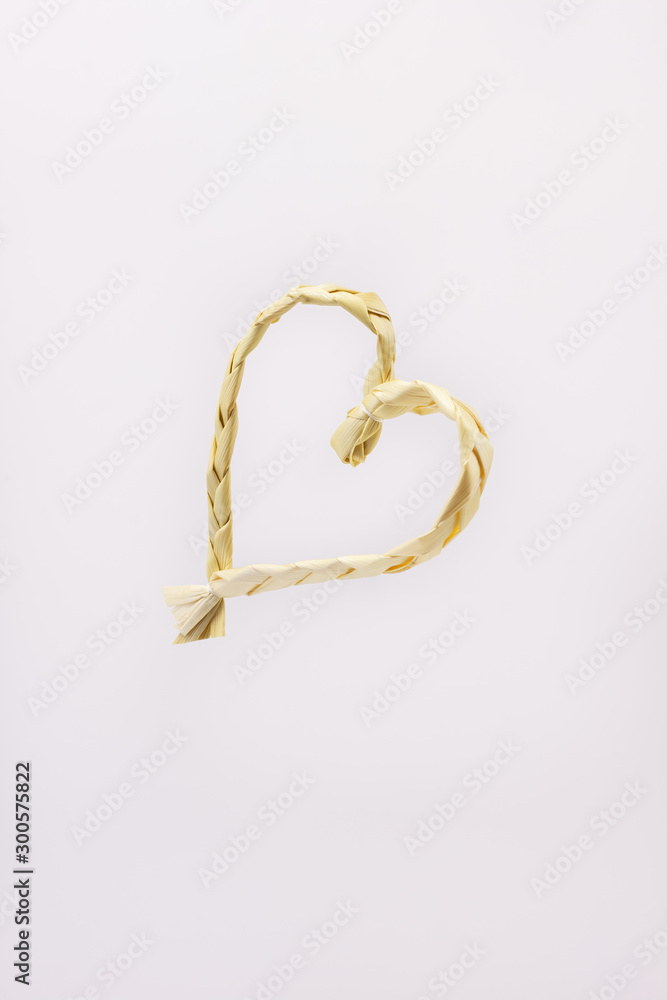 Heart woven of straw on a white background Heart woven of straw on a white background