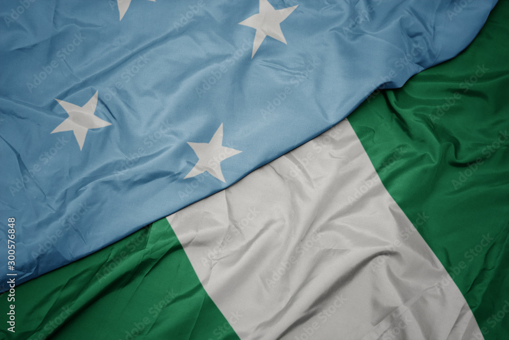 waving colorful flag of nigeria and national flag of Federated States of Micronesia . waving colorful flag of nigeria and national flag of Federated States of Micronesia .