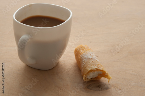 Fototapeta Naklejka Na Ścianę i Meble -  Sweet snack with coffee and waffle tubes on wood background