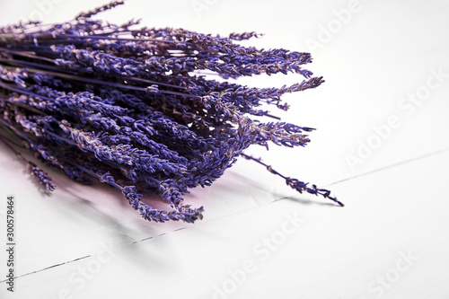 Fototapeta Naklejka Na Ścianę i Meble -  Dried lavender flowers on wooden table, bunch of purple lavender plants on white background