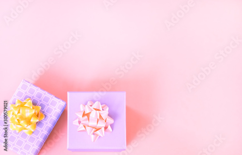 Gift boxes on pink background banner. © Alla