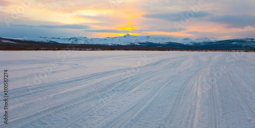 Sunset and winter road in the east of Russia.
