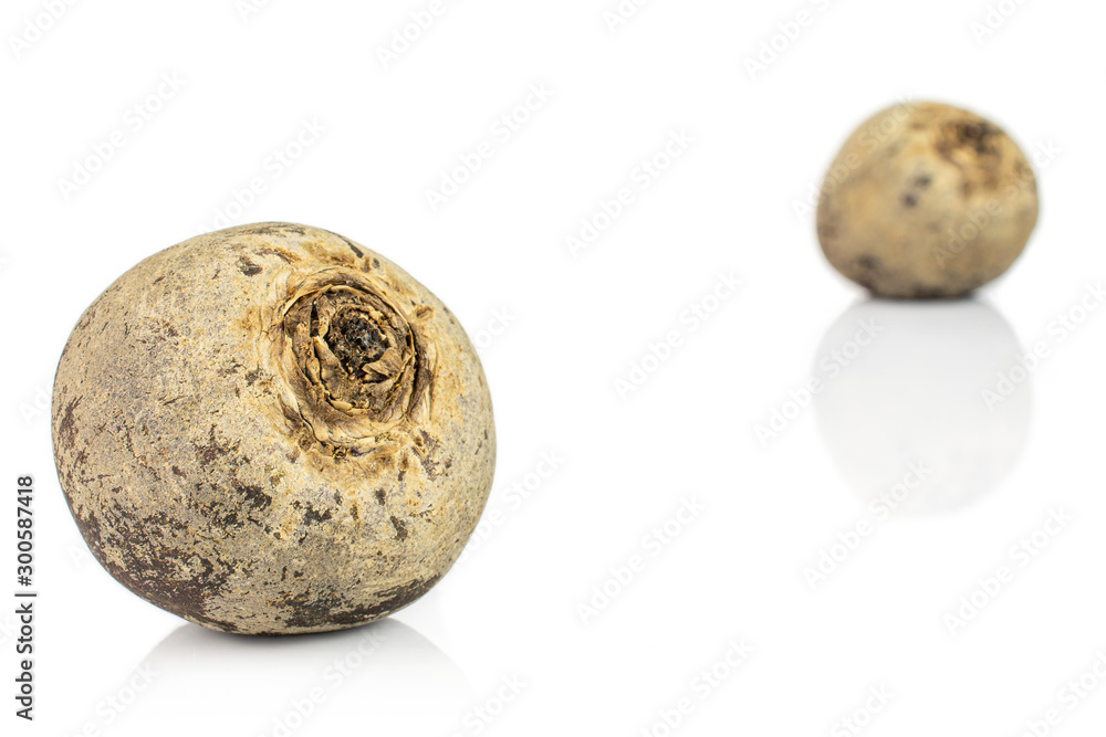 Group of two whole raw red beetroot isolated on white background
