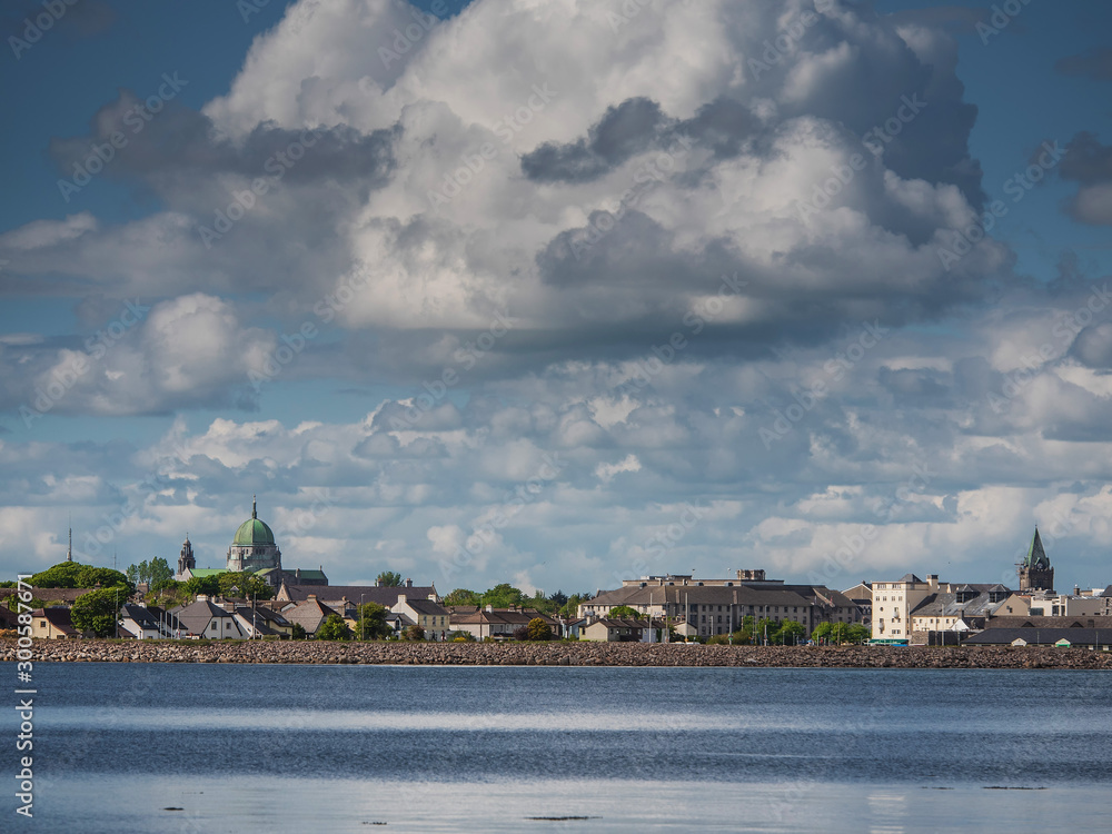 Galway city and bay, cloudy sky, Cathedral dome. blue water, sunny day.