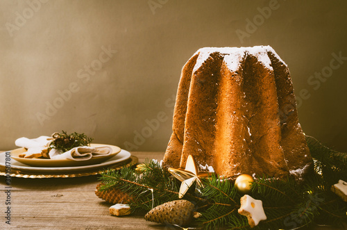 Pandoro -typical Italian christmas sweet yeast bread on old rustic wooden table. photo