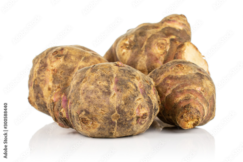 Group of four whole fresh brown jerusalem artichoke isolated on white background Group of four whole fresh brown jerusalem artichoke isolated on white background