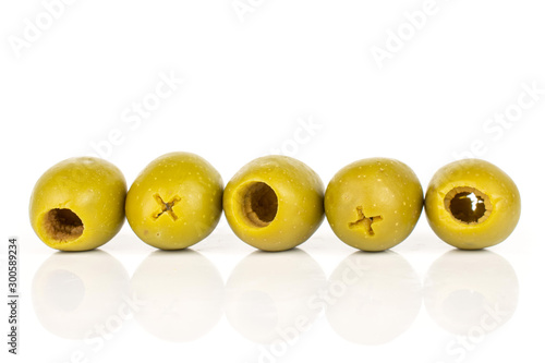 Group of five whole pitted green olive isolated on white background