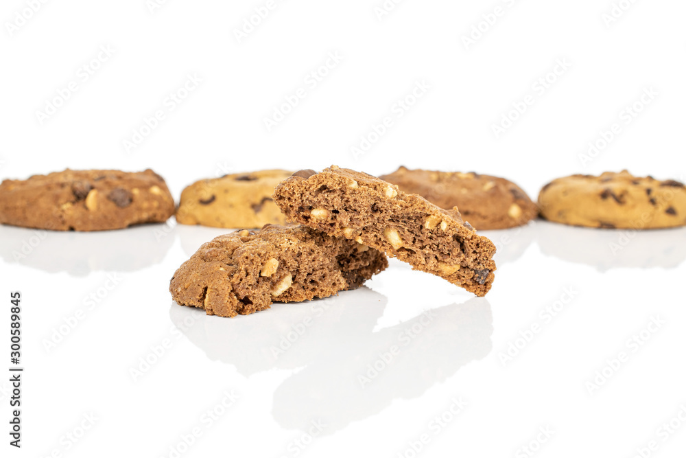 Group of four whole two halves of sweet brown cookie one cracked in focus isolated on white background Group of four whole two halves of sweet brown cookie one cracked in focus isolated on white background
