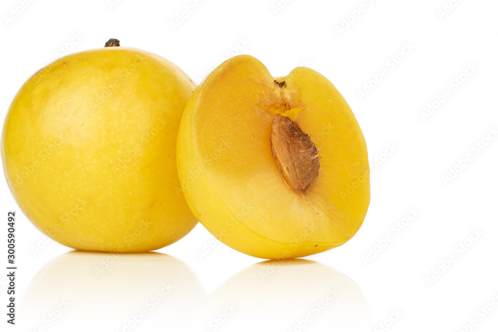 Group of one whole one half of fresh yellow plum isolated on white background Group of one whole one half of fresh yellow plum isolated on white background