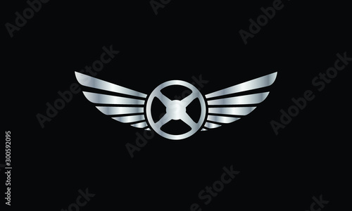 Silver steering wheel with wings emblem on a black background