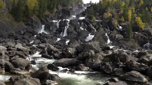 Scenic waterfall Uchar cascade view with currents and boulders. Altai mountains, Siberia, Russia. photo