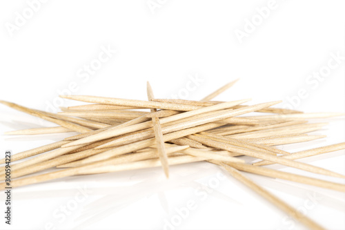 Lot of whole wooden brown toothpick heap isolated on white background photo