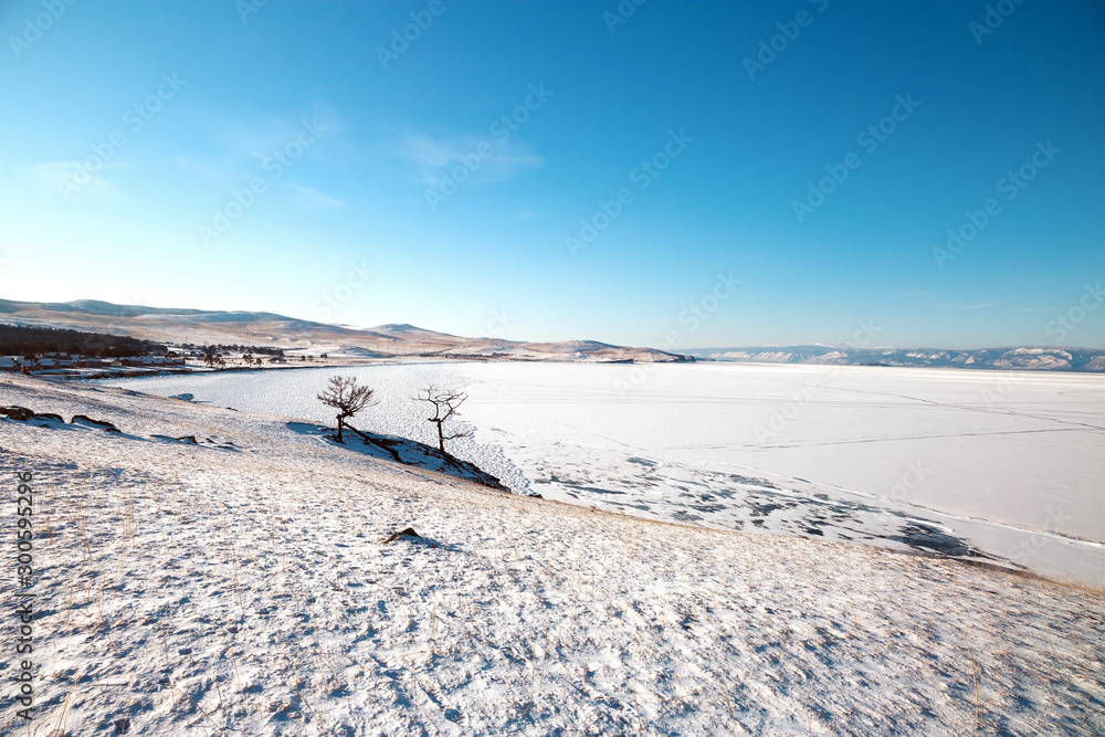 Winter landscape with lake covered with ice.Lake Baikal, Russia